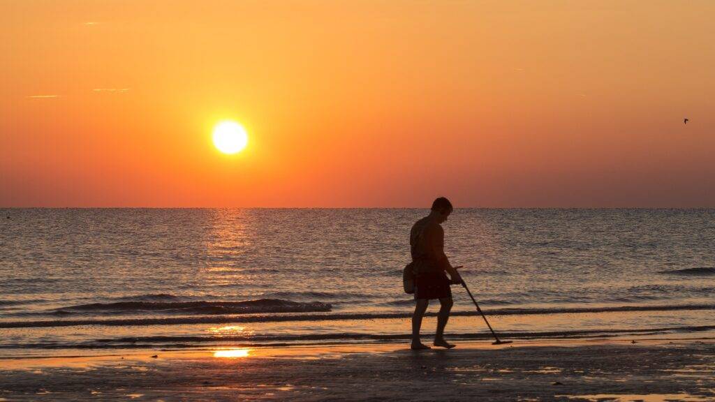How to metal detect responsibly man on beach